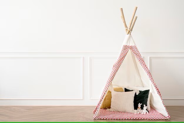 A teepee made from wooden dowels and blankets